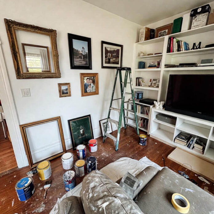 Cluttered living room corner in mid-DIY painting chaos.